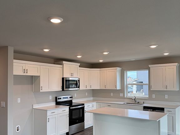 Kitchen with stone coutertops.
Stainless Steel Refrigerator has been installed.
