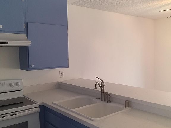 Kitchen overlooks Dinning/Den Area and Patio