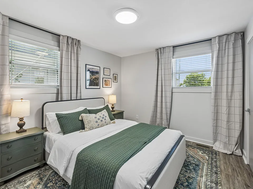 Bedroom 2 with a queen bed, room darkening shades, end tables, and closet space to store your things.