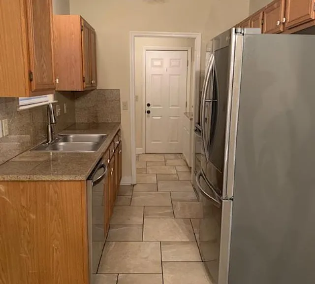Kitchen located to the right of the dining area
Beyond the kitchen is the Laundry Room and the door at the very end opens into the garage.