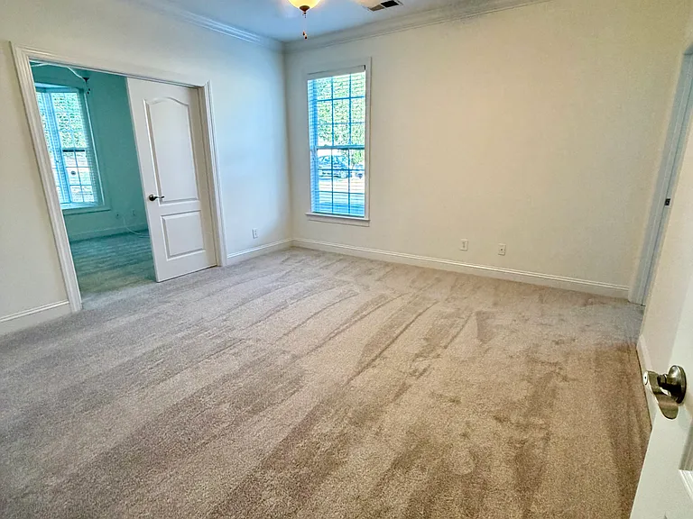 large primary bedroom. In the photo, the double doors lead to either a third bedroom with closet or your private office space with large bay window