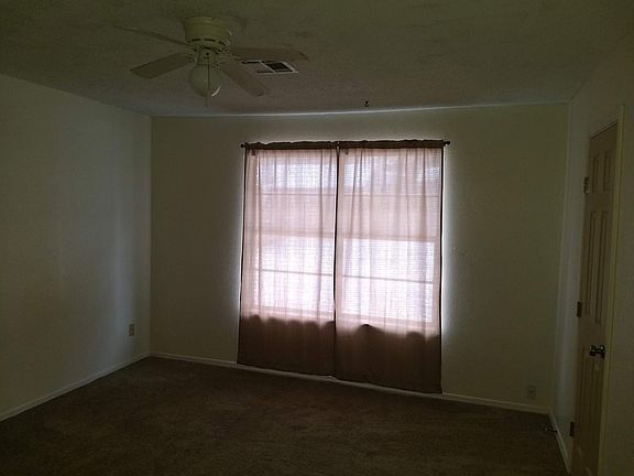 Master bedroom with bathroom to the right and window facing back yard.
