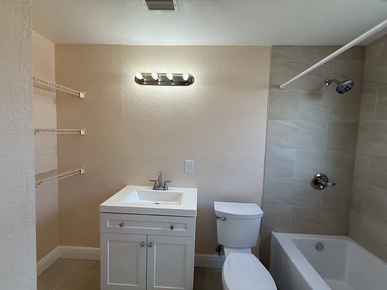 Updated Primary Bathroom with linen shelf on left side