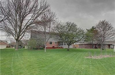 Exterior Back. Spacious back yard with 3 season room and deck for entertaining.