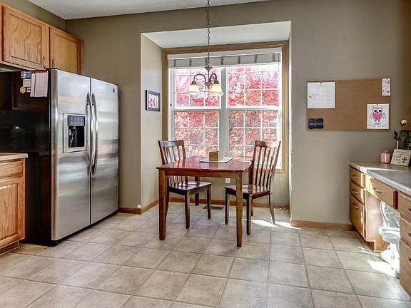 Spacious kitchen with stainless steel appliances, ceramic tile backsplash and 42" cabinets.