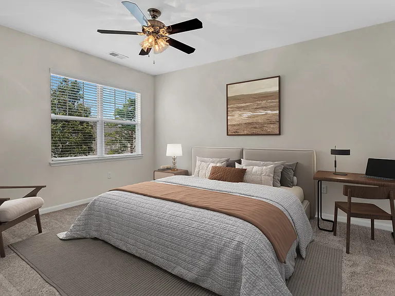 Spacious bedroom with plush carpeting