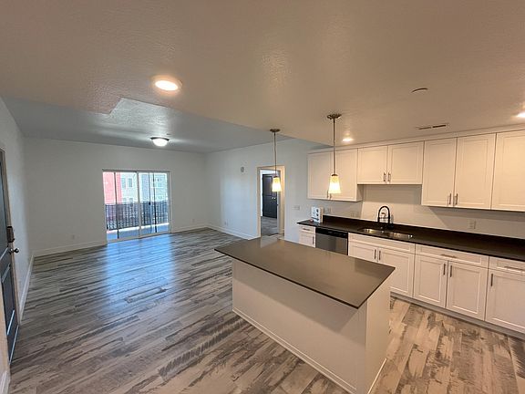 The entrance to the condo is through the door on the left. Enjoy mountain views from the covered balcony.