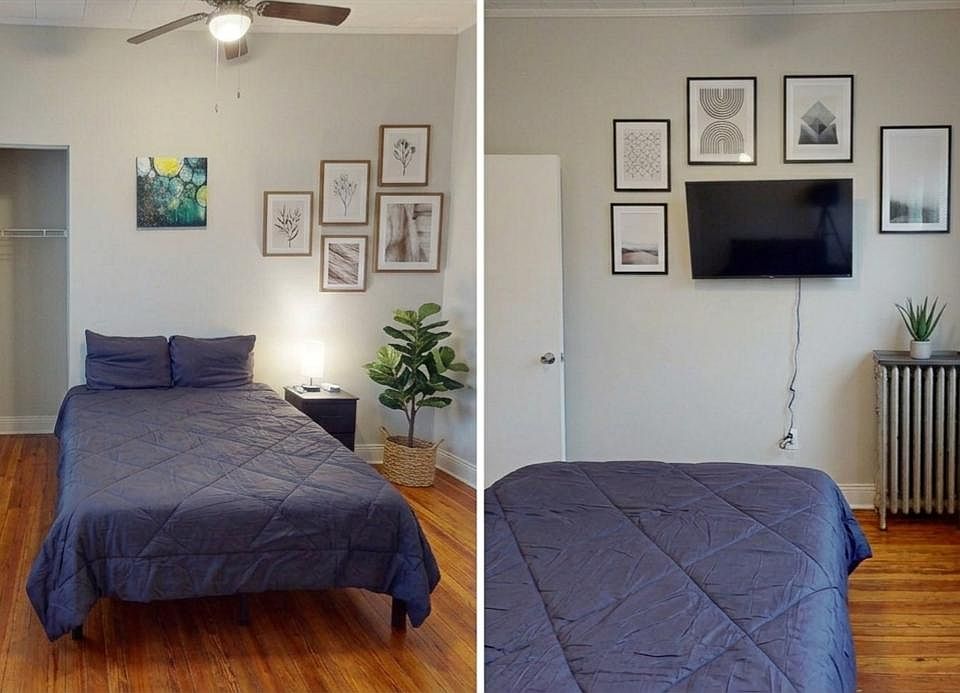 Room features private bathroom, mounted flat screen tv, hardwood floors, full-size bed, side table lighting, and wall art.