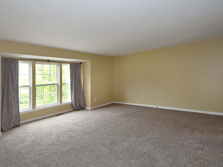 Neutral colored living room with lot of potential for furniture options.