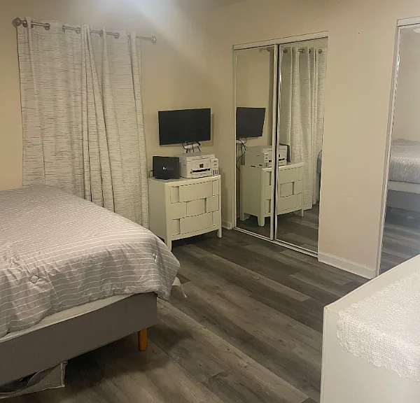 27" Monitor mounted on wall in back bedroom