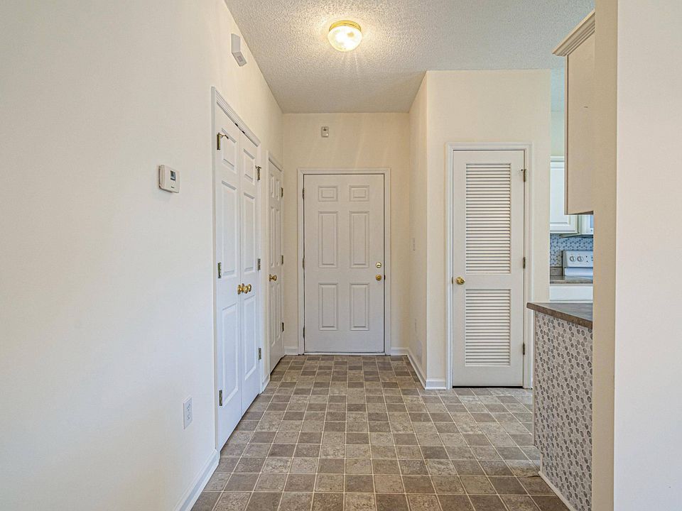 Facing entrance into condo before it was furnished. Large pantry is located on the left along with a coat closet.