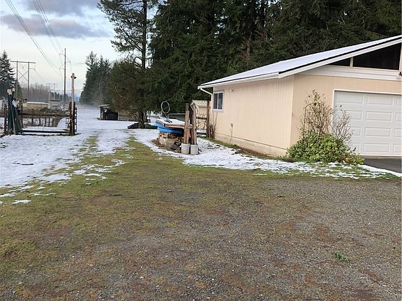 West side of garage looking down the "road" path to the acreage with stable and 2nd tax parcel. 