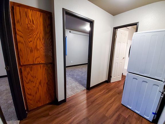 Small common area with entryway to both room and bathroom, featuring the new European style washer and dryer.