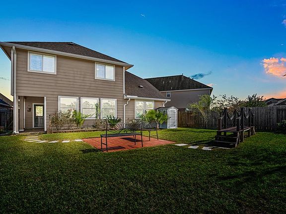 A twilight shot of the beautiful backyard, imagine the memories you will be making in this beautiful outdoor space.