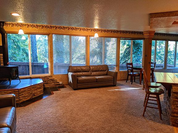 Open floor plan living room with wood stove