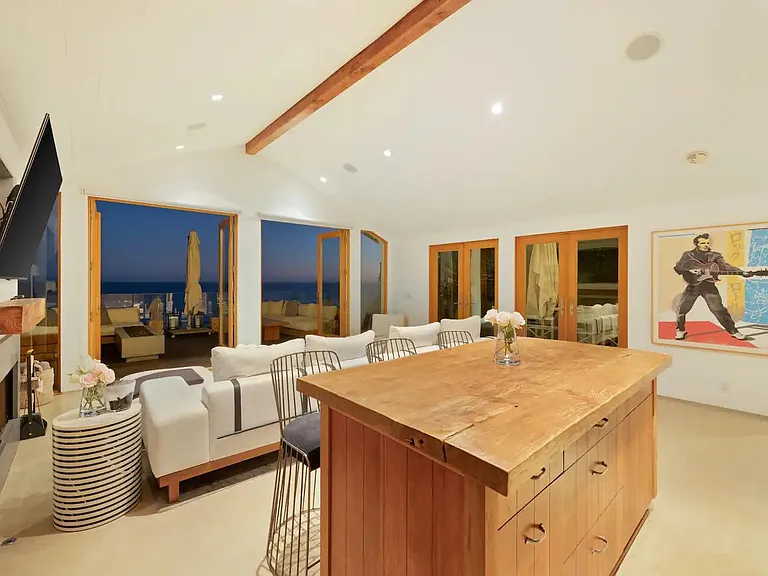 Additional seating at the wooden kitchen counter island.