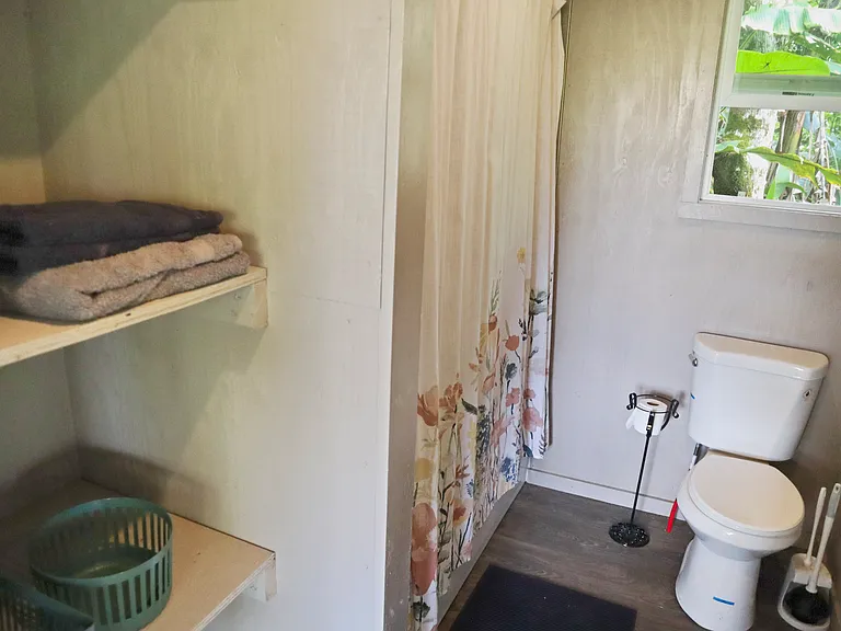 Full bathroom with bathtub, toilet and sink.