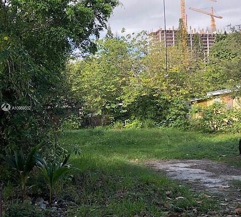 Build-able lot to accommodate 2 town homes, with Coral Gables construction in the distance