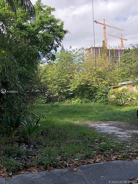 Build-able lot to accommodate 2 town homes, with Coral Gables construction in the distance