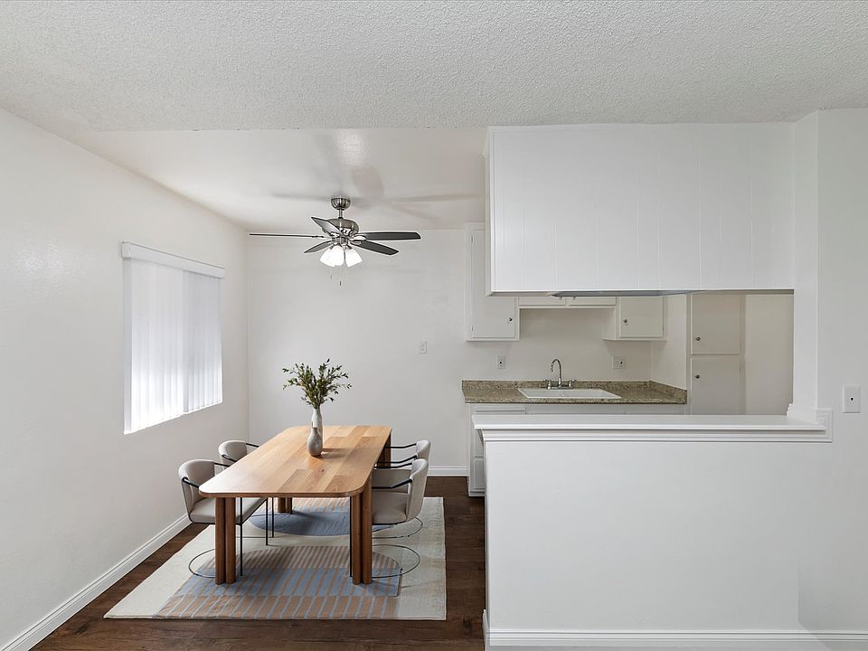 Dining Room with Ample Natural Light and Modern Ceiling Fan