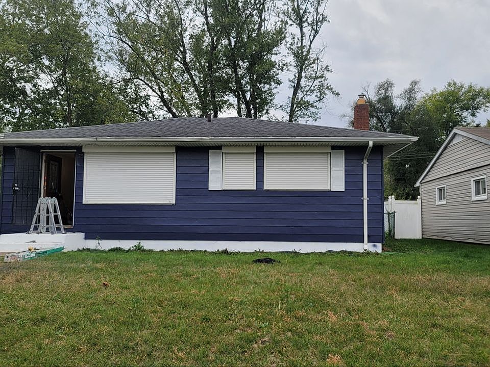 Outside of house getting painted for you. Notice the rollling shutters