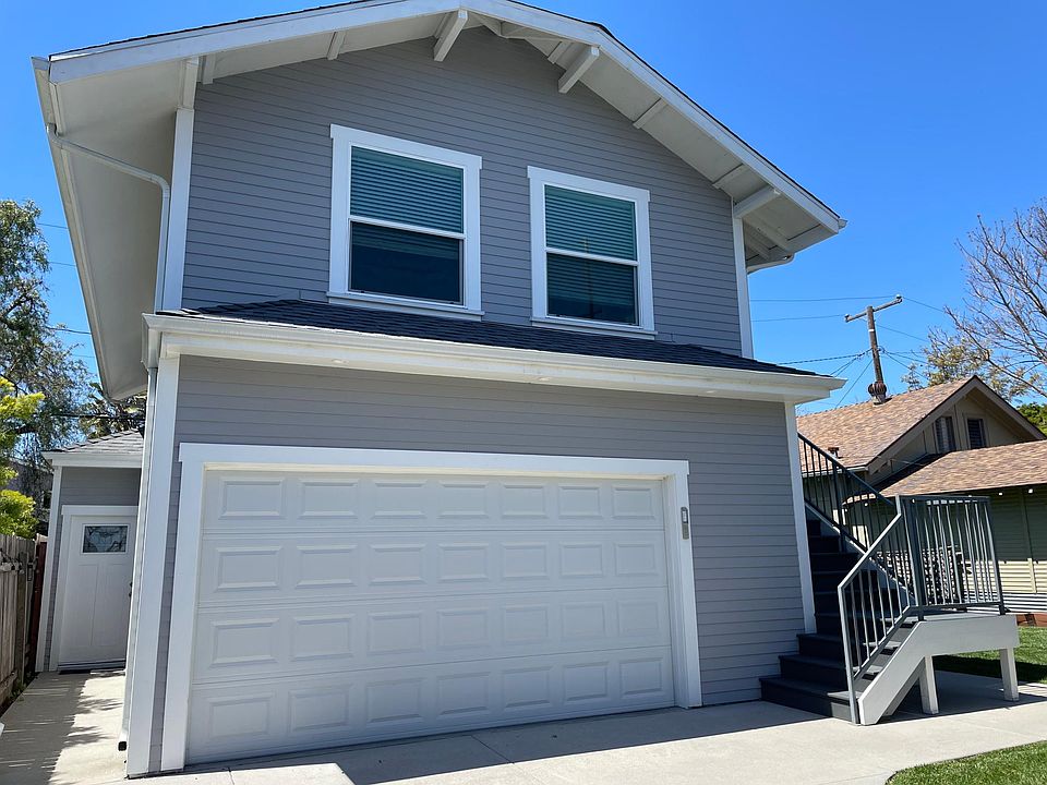 Upstairs rear unit with small storage area and private laundry in shared storage garage.