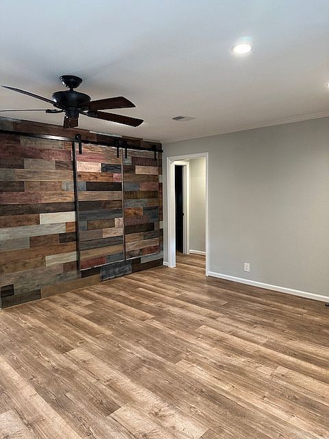 Wood wall in living room with hidden bookcases.