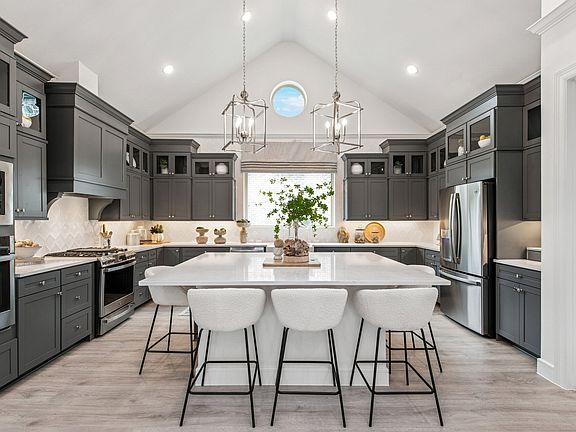 Kitchen with stunning stacked cabinetry with glass-front uppers