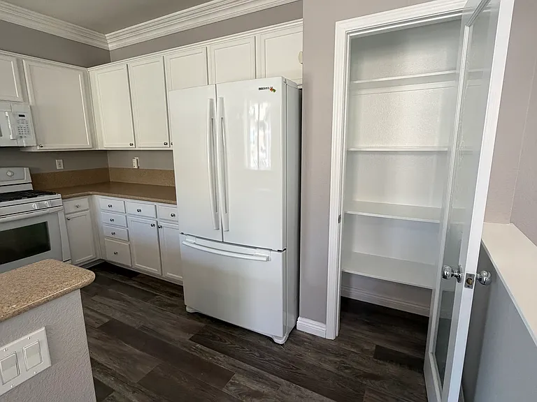 Spacious pantry provides ample storage for food, small appliances, and kitchen essentials.