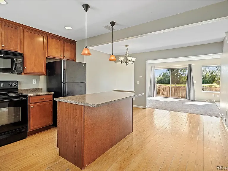 Entrance view. Open kitchen with island and living room with lots of natural light. (upgraded stainless steel appliances not pictured)
