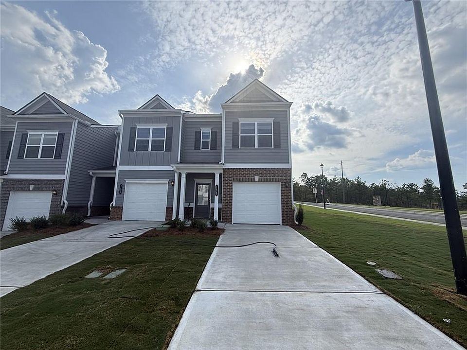 Multi-story exterior with a combination of brick and siding, featuring a covered entry and attached