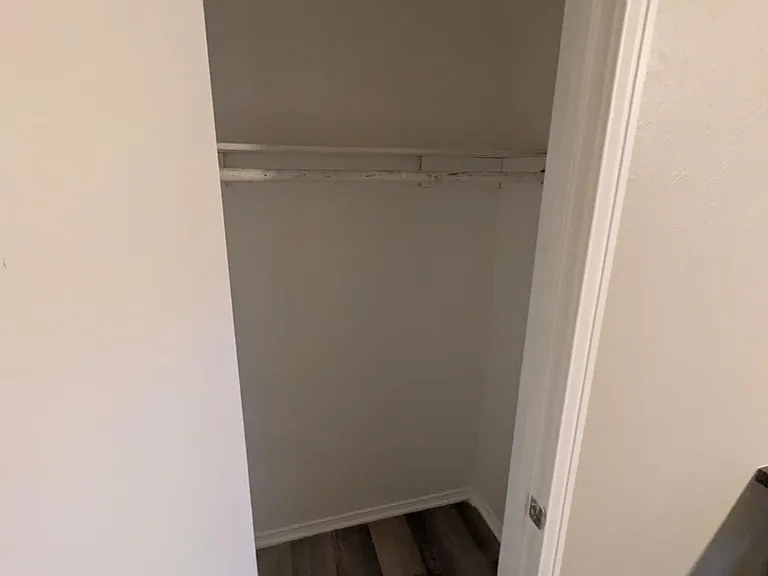 Dedicated closet space with a hanging rod and upper shelf, offering convenient storage for clothing and essentials.
