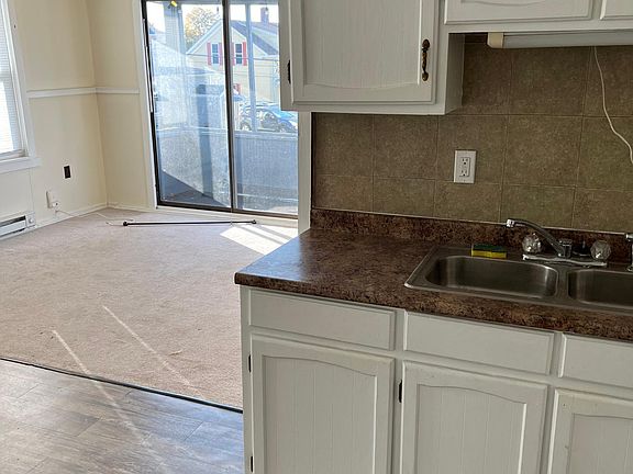 Living room carpet with nice sized balcony and plenty of outlets.