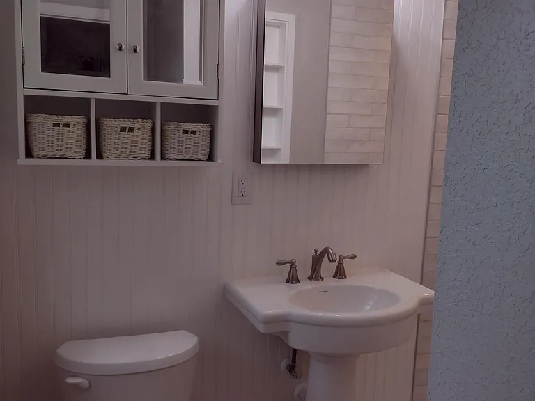 Pale greens, grays, blue and lilac complement this newly renovated bathroom