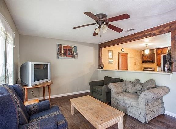 Living area with breakfast bar that opens to kitchen/dining.