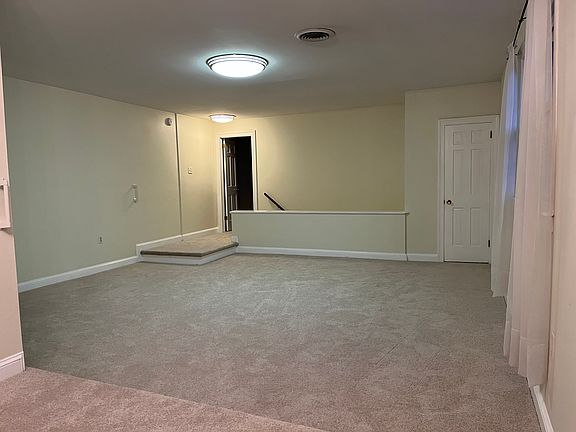 Standing in dining room and looking towards living room / stairs to the front door. Doorway on the left is the first bedroom. Doorway on the right is the living room closet.