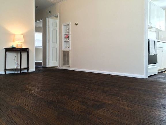 The living room connects to the kitchen, and the hallway leads to both bedrooms and full bathroom.