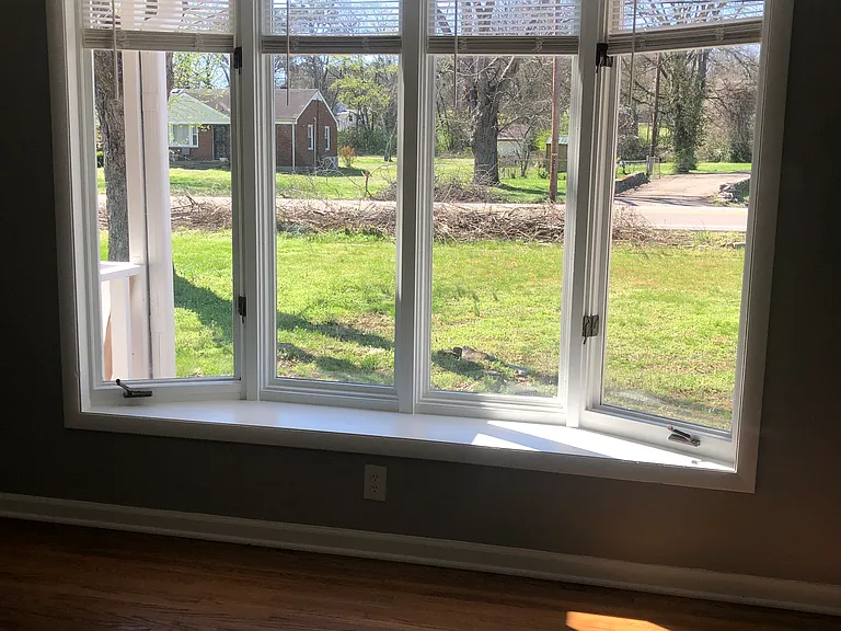 Bay windows allow sun filled living room