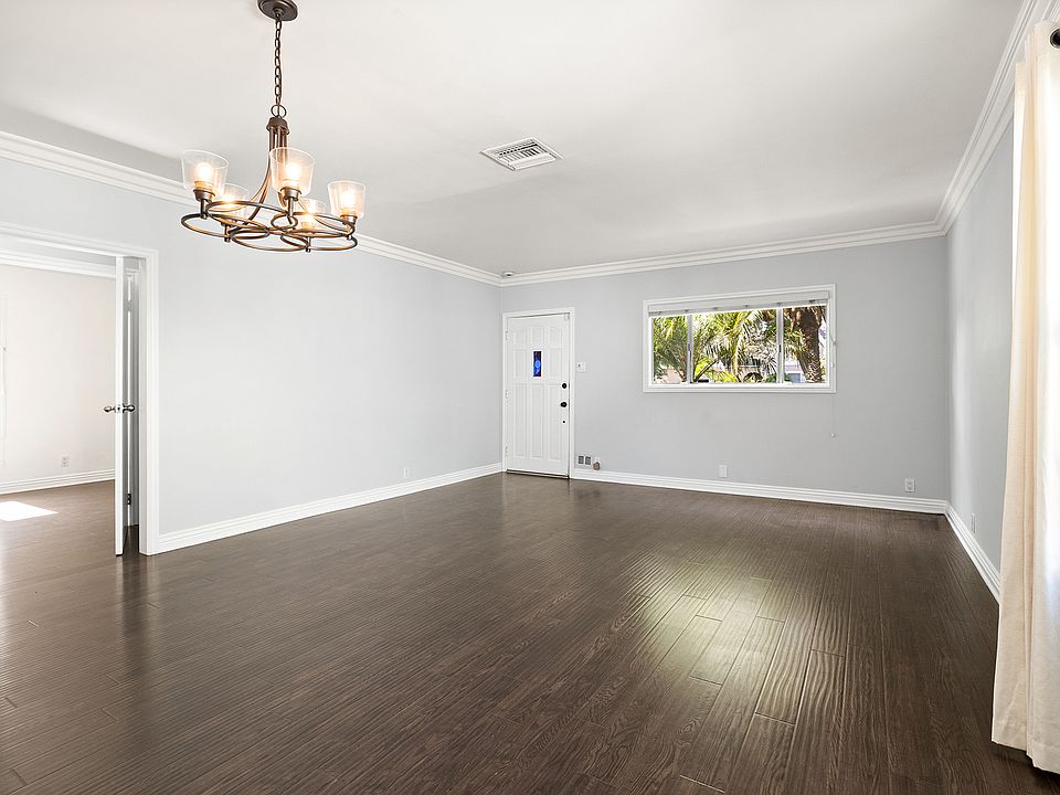 Bright, spacious living room with durable laminate, pet-friendly hardwood-style floors and excellent natural light.