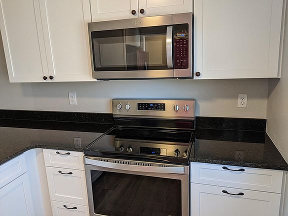 Stainless Microwave, range, and oven with ample preparation space.