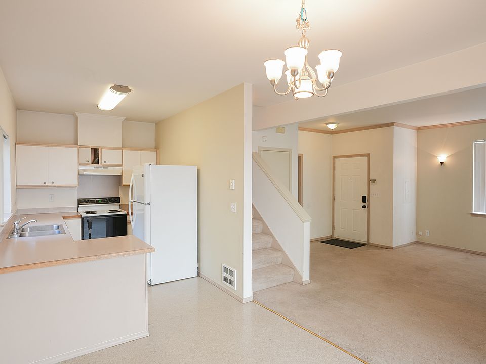 From dinning area looking toward kitchen and living room. Note: Stove/range has been replaced with glass top stove/range.