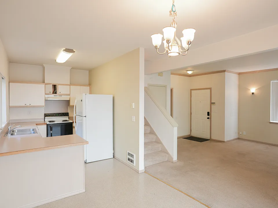 From dinning area looking toward kitchen and living room. Note: Stove/range has been replaced with glass top stove/range.