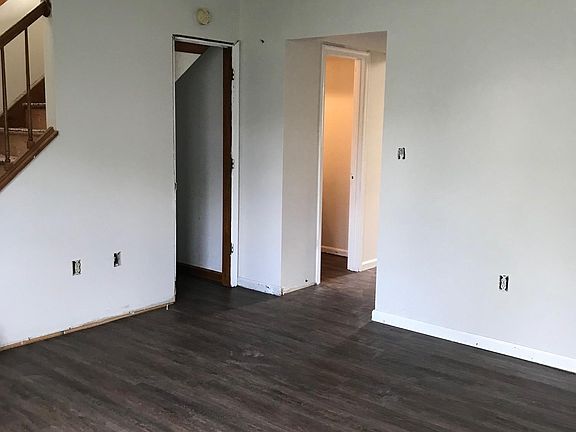 Living room with new vinyl plank flooring! Final trim and touch up paint to be completed. Light switch covers to be installed.