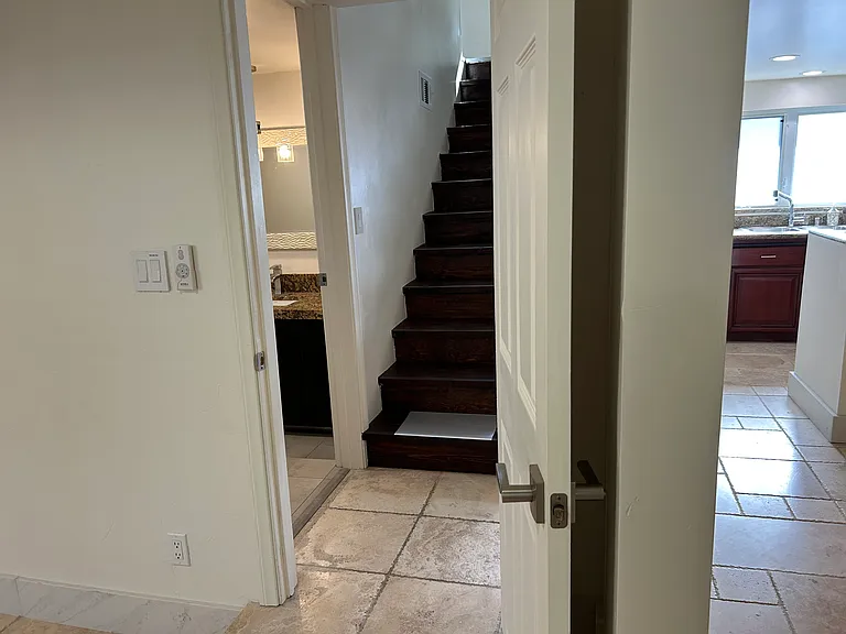 Stairs to upstairs and full bathroom at first floor.