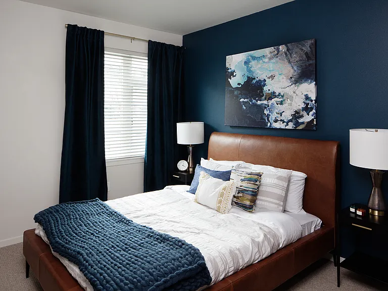 Grant park village bedroom shot of bed and blue accent wall
