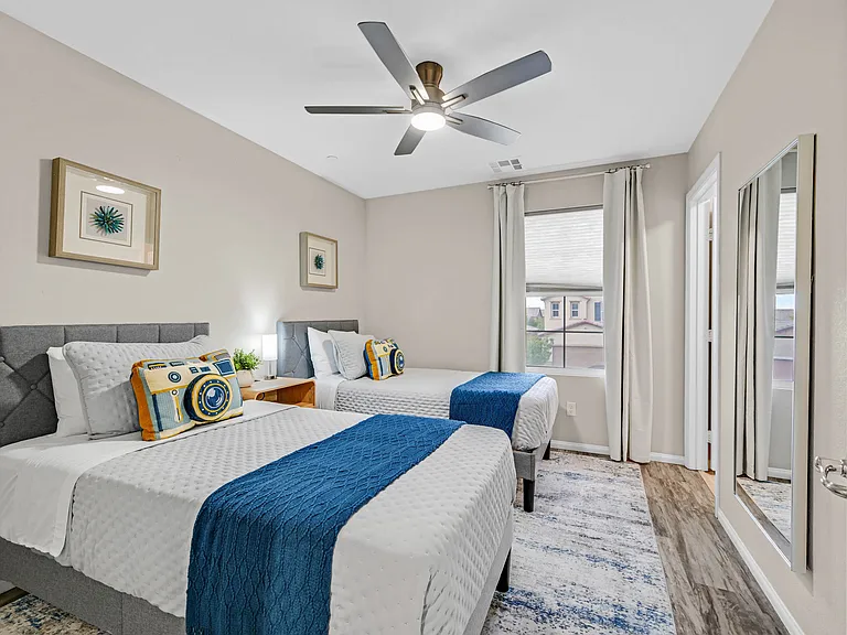 Bedroom 3 with two Twin size beds, walk-in closet, ceiling fan, and black out curtains