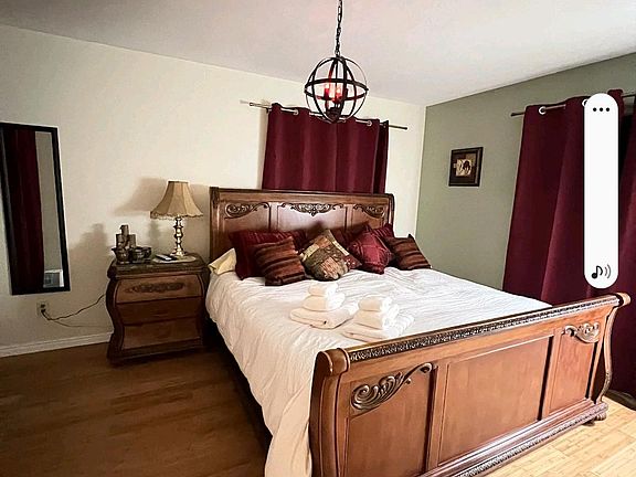 Large "Royal Zen" bedroom with a beautiful, comfy king-sized sleigh bed,, bamboo flooring, new window coverings, and a new sheik ceiling fan. All bedding is included.