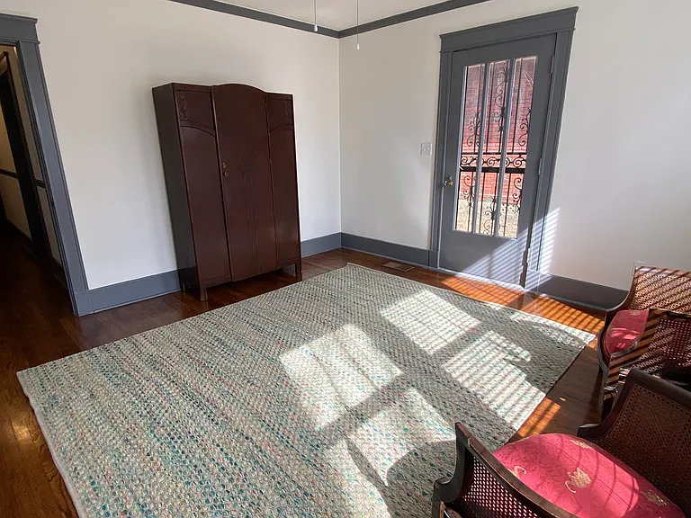 Beautiful light filled front room to use as a bedroom or office with private entry. Rug, Armoire, & Chairs included if needed.
