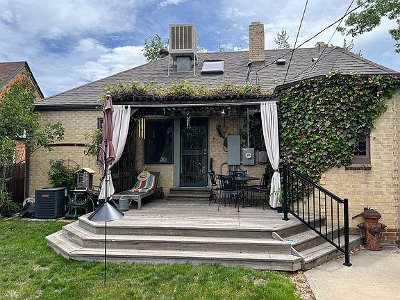 Back yard with west-facing patio, nicely shaded from pergola with mature grape vines (that produce ample, sweet concord grapes in fall) - this is an ideal space for watching Denver's incredible sunsets. Bird feeders can remain in place or be removed.
