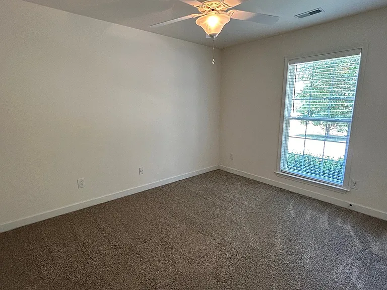 Bedroom #2 with ceiling fan and newer carpet